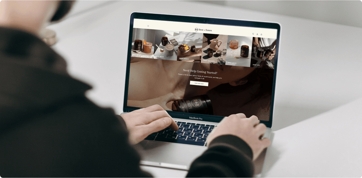 A customer browsing the Root + Bones homepage on a laptop
